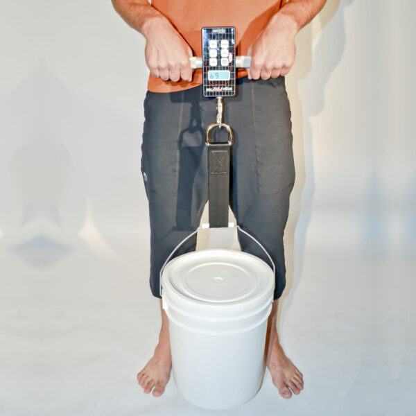 Using the ergoFET 500, a man is seen holding a bucket with a weight attached to it.
