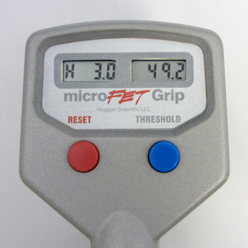 A microFET Digital Hand Evaluation Kit, part of a digital hand evaluation kit, is shown on a white surface.