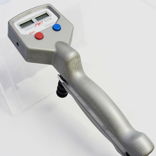 A microFET Digital Hand Evaluation Kit with a red light on it.
