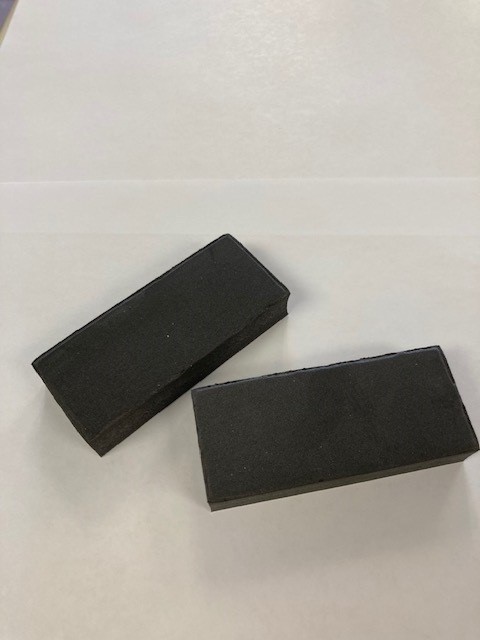 Curved foam block in black on a white background